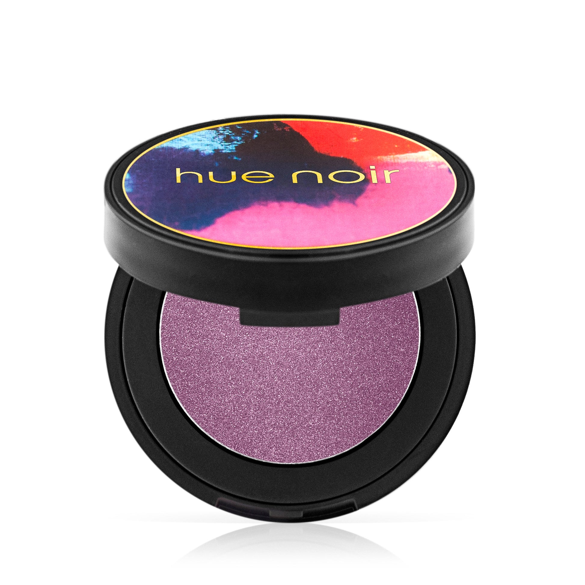 Hue Noir Perfect Pigment Velvet Eyeshadow in Serengeti Sunset, an open compact with a shimmery purple shade inside.