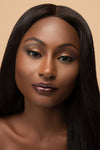 Model wearing nude brown lipstick and shimmery clear lip gloss overlay