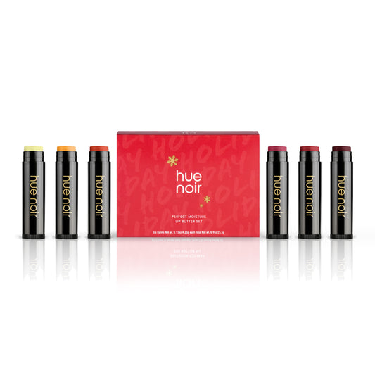 tinted lip balm set of six with clear, gold, copper, rose, ruby and wine shades along with red holiday themed product carton