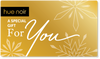 Hue Noir holiday gift card gold color with sparkly snowflakes design