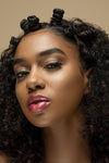 Model wearing fuchsia pink lip gloss and shimmery clear lip gloss overlay
