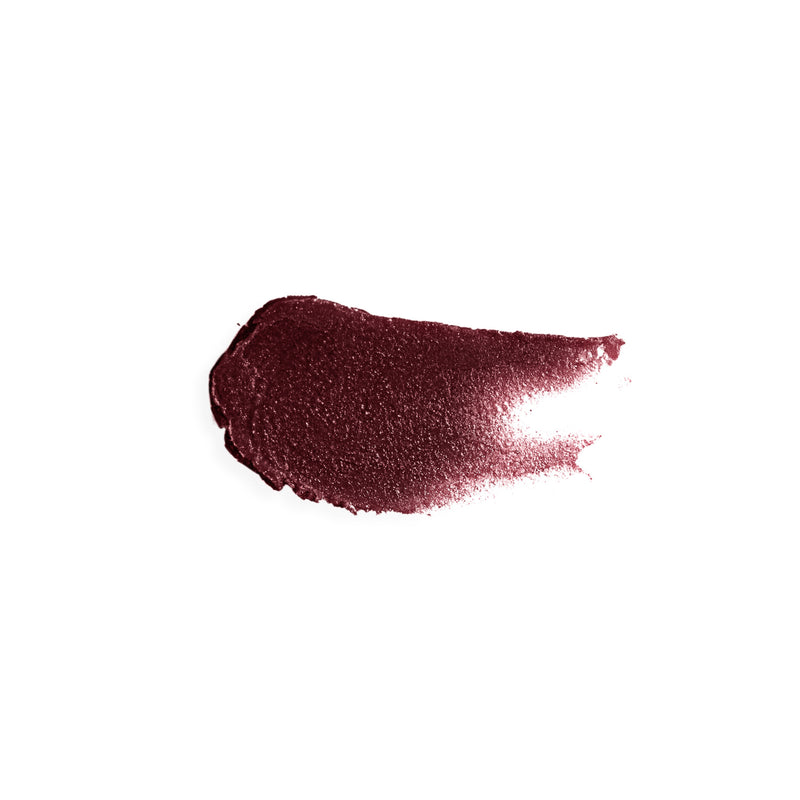 Smear of wine burgundy tinted lip balm showing burgundy color and creamy texture