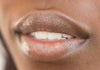 Photo of models lips with clear tinted lip balm applied